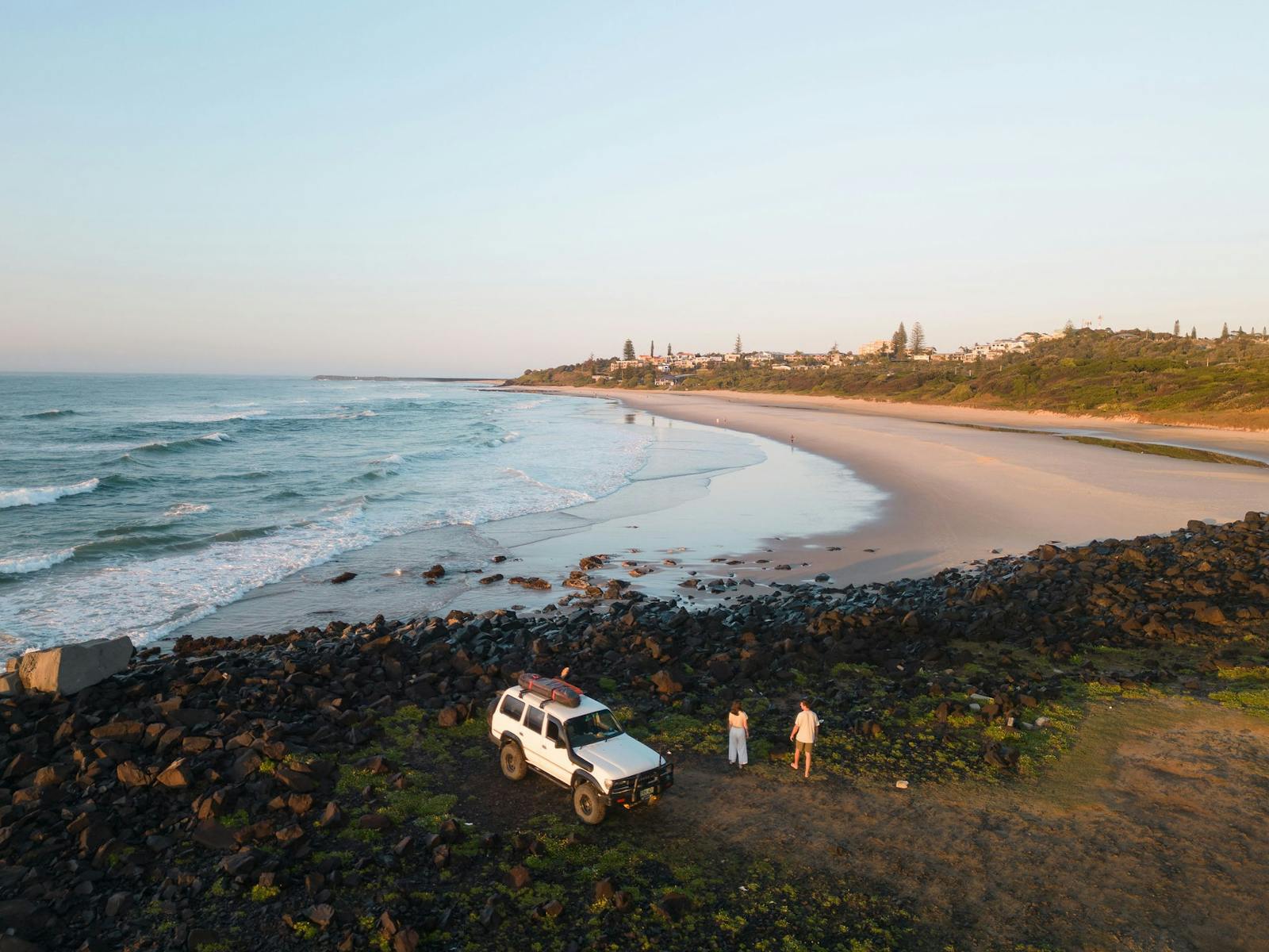 A quiet Ballina beach at golden light in autumn with empty sand and gentle surf